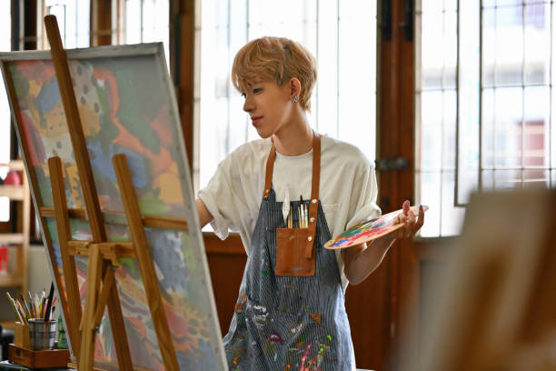 istock Young Asian LGBT artists doing artwork in the workshop studio 1700357062