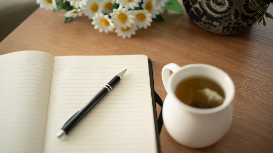 Diary and herbal tea standing on the table