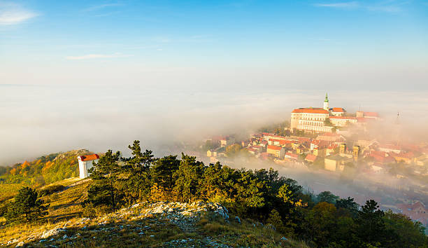 Mikulov, Moravia, Czech Republic Mikulov covered with morning fog. View from Svaty Kopecek. jainism photos stock pictures, royalty-free photos & images