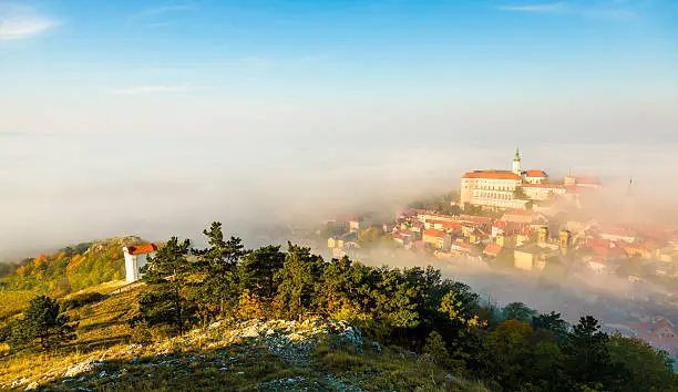 Mikulov covered with morning fog. View from Svaty Kopecek.