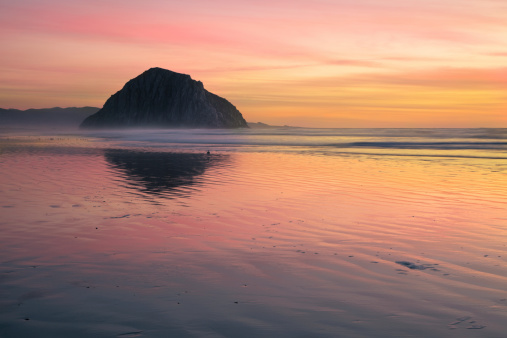Lovely sunset on the north side of Morro Rock, in Morro Bay, California. Morro Rock is a volcanic plug, part of the Nine Sisters of San Luis Obispo County that string from San Luis Obispo to the Morro Rock.