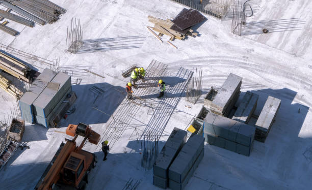 istock Top view: builders working with a metal rebars at the construction site 1700365455