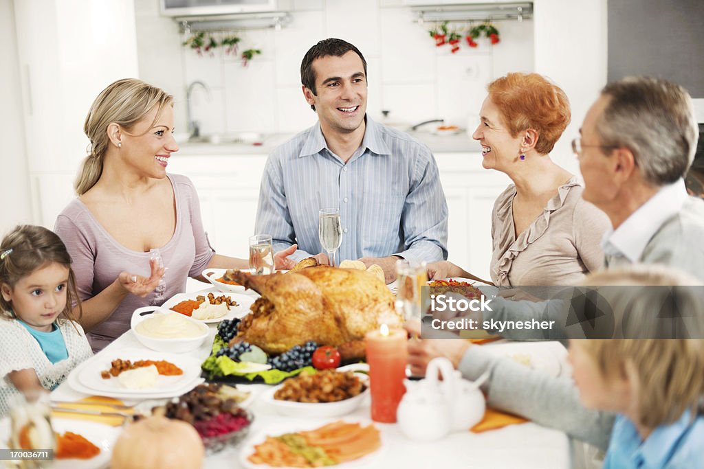 Extended family celebrating Thanksgiving day. Happy extended family having family lunch on a Thanksgiving day.    Large Family Stock Photo
