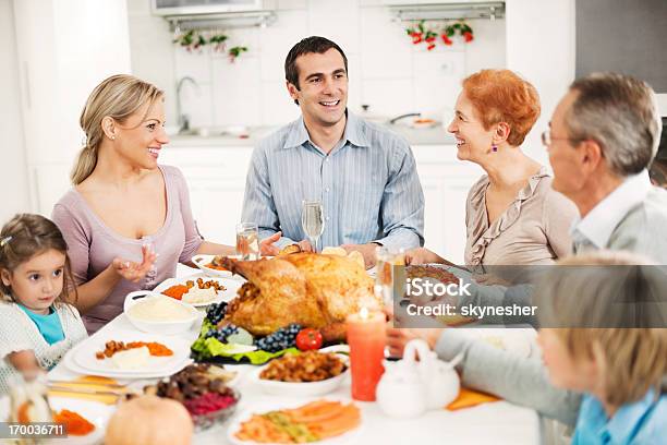 Extended Family Celebrating Thanksgiving Day Stock Photo - Download Image Now - Large Family, Thanksgiving - Holiday, Indoors