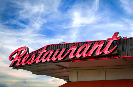 A vintage neon restaurant sign along old Route 66.