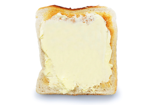 Overhead view of buttered toast isolated on white.