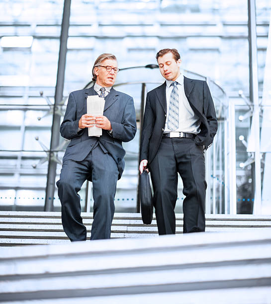 istock Two businesspeople going down the stairs. 170037193