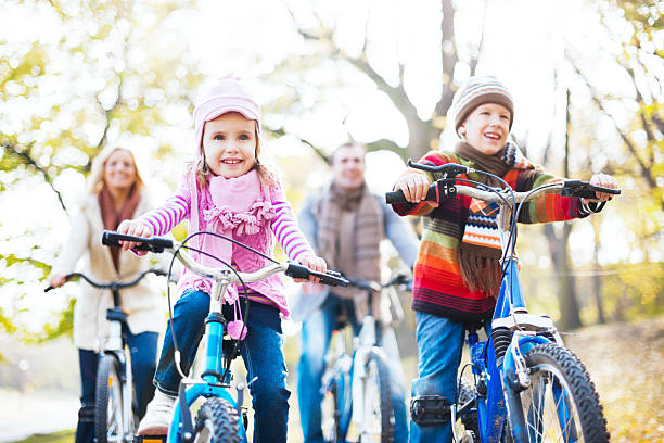 Happy family riding bicycles in nature.
