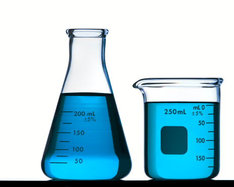 A Back Lit Image of an Erlenmeyer Flask and a Beaker filled with Colorful Fluid.  Isolated on White with Clipping Path.