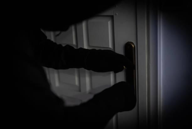 istock Thief opening door with lock picker. 1700375905