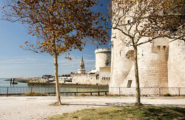 La Rochelle on the west coast of France. Closest is Tour Saint-Nicholas. On the other side of the harbor entrance is Tour de la Chalne. Taken in early October.