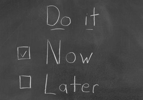Do not procrastinate, Do It Now, written on a blackboard.