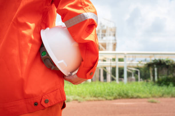 istock Engineer holding safety helmet with refinery plant. 1700416619