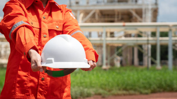 istock Engineer holding safety helmet with refinery plant. 1700416655