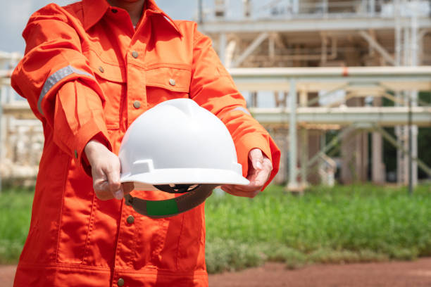istock Engineer holding safety helmet with refinery plant. 1700416658