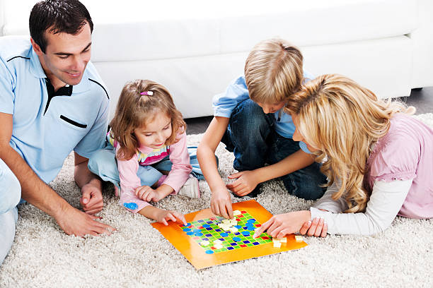 istock Cheerful parents playing board game with their children. 170041709