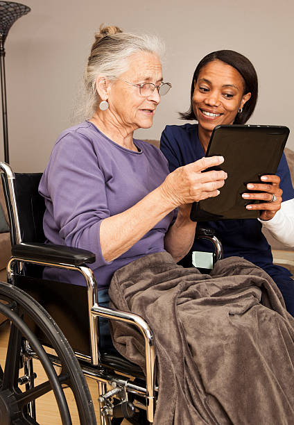 istock caregiver and elderly on digital tablet 170042654