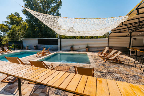 istock Outdoor Swimming Pool With Lounge Chairs In The Backyard 1700431490