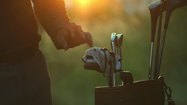 Golf Bag and Golf Clubs with sunset