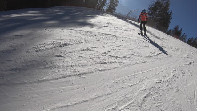 Adult woman enjoying skiing slalom on a Dolomites slope