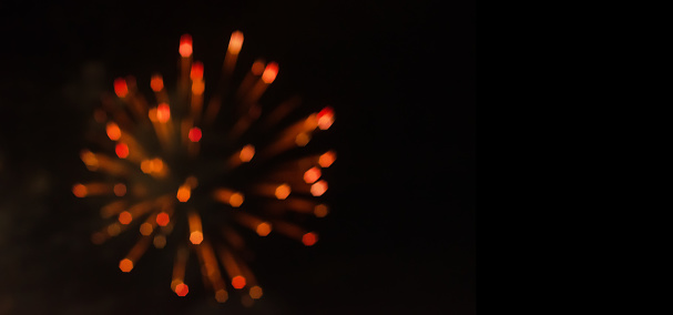 Blurred bokeh orange firework background, copyspace