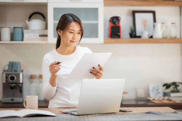istock Asian woman working at home 1700439136