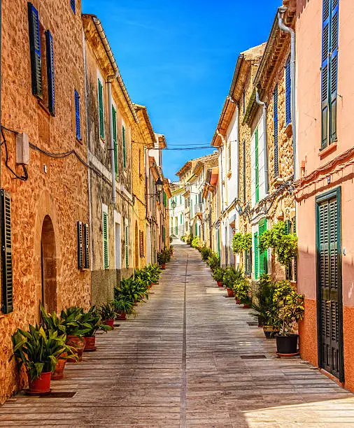 Beautiful street with traditional majorcian houses in the town of Alcudia, Majorca (Spain).