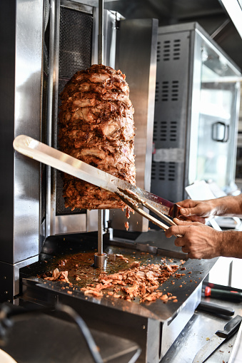 Thin Slice Cutting From Beef Meat On Rotisserie By Doner Chef