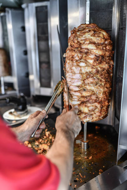 istock Chef Cutting Out Pieces Of Chicken Doner Meat 1700449040