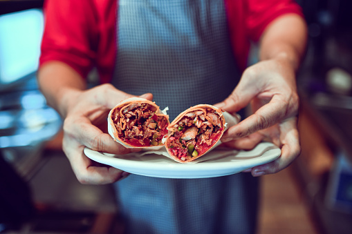 Neatly Wrapped Pieces Of Pita With Ingredients Inside Presenting The Perfect Doner Kebab