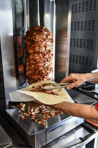 Chef Filling Pita Bread With Thinly Cut Doner Meat