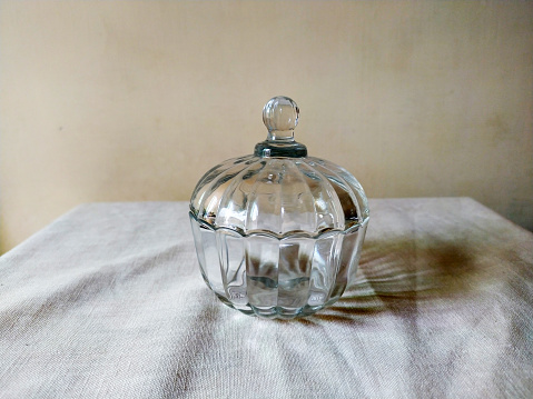 A glass sugar pot with glass cover for serving sugar in it