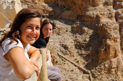 Two young woman backpacking in the Middle East and enjoying the view at Deir Mar Musa, Syria