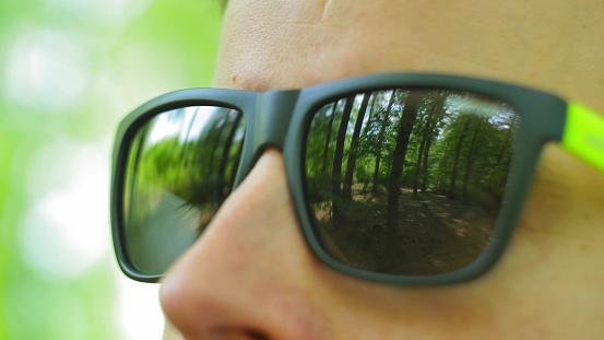 Man in Sunglasses Looking Around in Forest Close Up POV