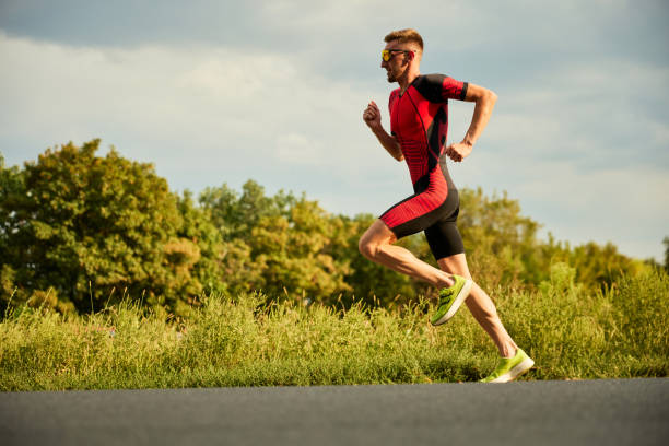istock Dynamic image of competitive man in sportswear, athlete training outdoors on summer day, running. Marathon 1700469018