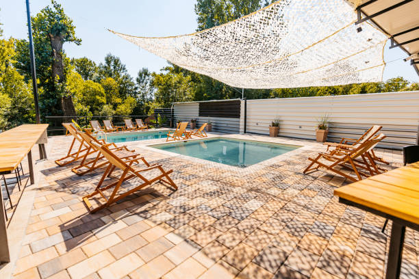 istock Outdoor Swimming Pool With Lounge Chairs In The Backyard 1700474829