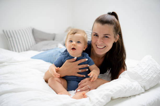 istock beautiful mother is cuddling with her cute baby 1700488575