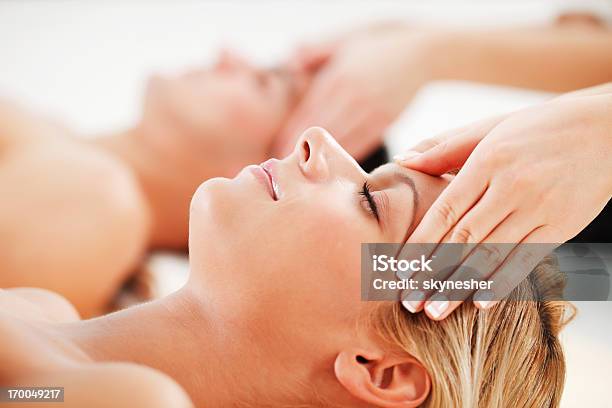Young Couple Is Having A Head Massage At Spa Centre Stock Photo - Download Image Now