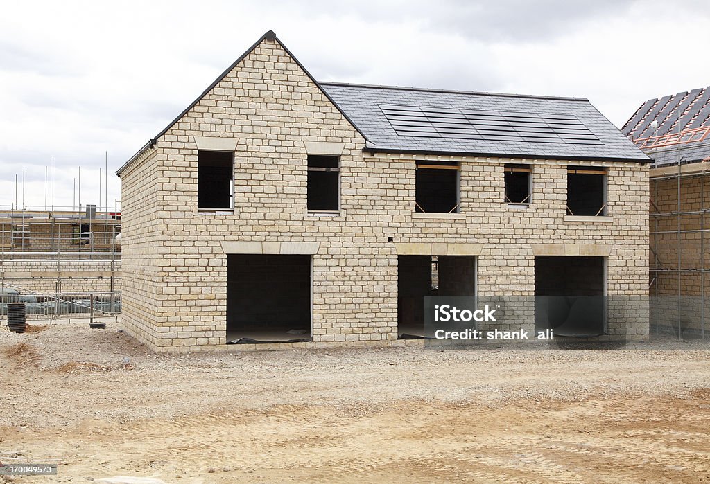 large new build A large house under construction with modern solar panels on the roof. House Stock Photo