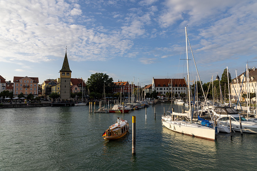 Lindau, view over the harbor into the city with ships, shops, houses and cafes