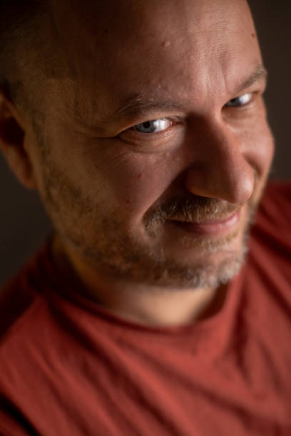 istock An unshaved man in his 40s, sporting a friendly smile and an average appearance, is captured in a close-up shot 1700505001