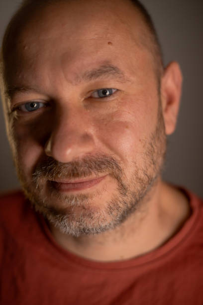 istock Close-up portrait of a casually unshaved man in his 40s, displaying a friendly expression and an everyday appearance 1700505013