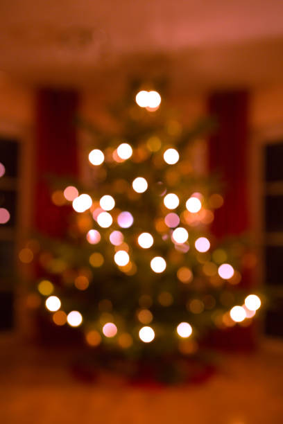 istock Decorated Christmas tree on blurred, sparkling and fairy background 1700515992