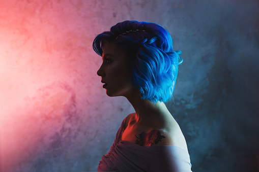 Blue hair woman in studio.