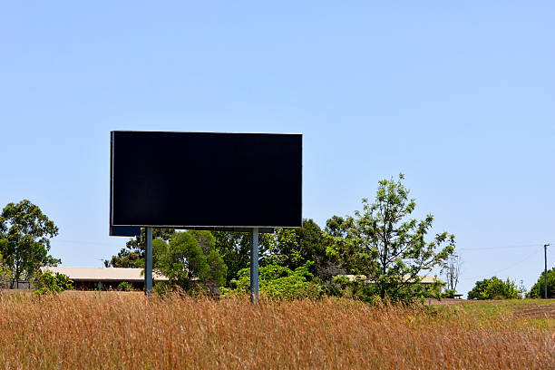 istock Black billboard sign in a dry field 170051818