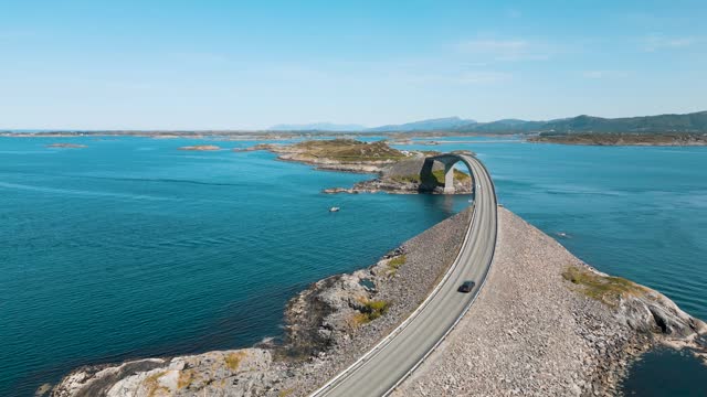 Aerial view of a car on Atlantic Road (Atlanterhavsveien) also known as ”The Road in the Ocean” in Norway. National Tourist Route