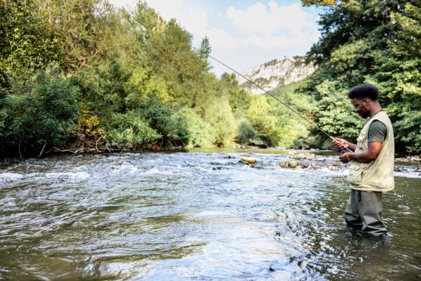 istock Fly fisherman catching fish on a mountain river 1700524806