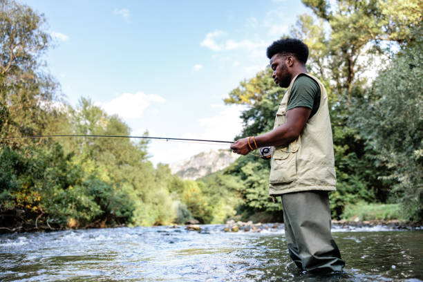 istock Fly fisherman catches fish on a river at sunset 1700525408