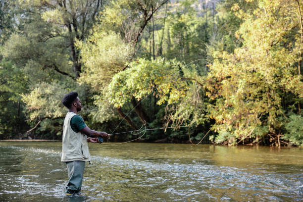istock Fisher casting on a mountain ricer at sunset 1700526022
