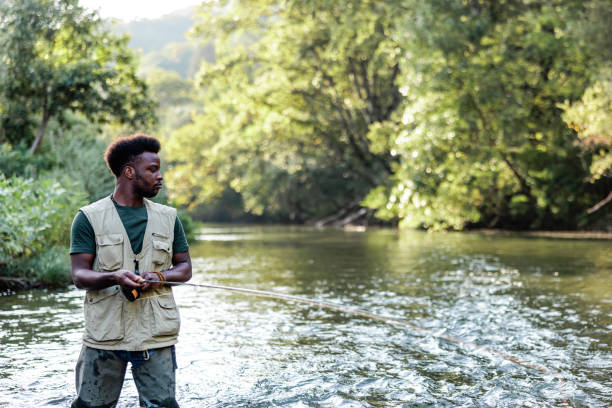 istock African American fisher catches a fish 1700526027